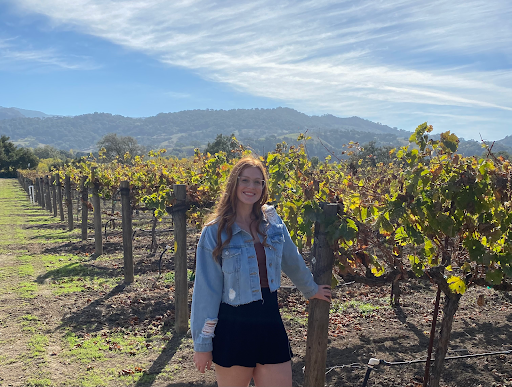Danielle poses at a vineyard for photo